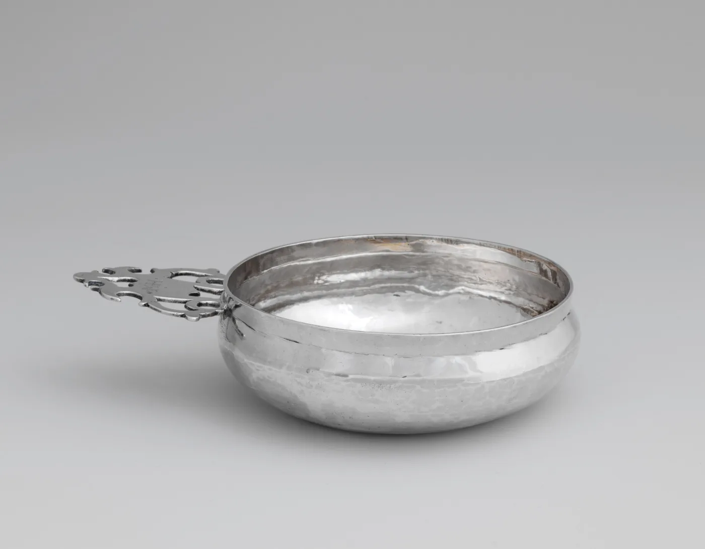 English silver porringer of 1685 to 86 by Thomas Cory of London with one flat pierced handle in a geometric pattern