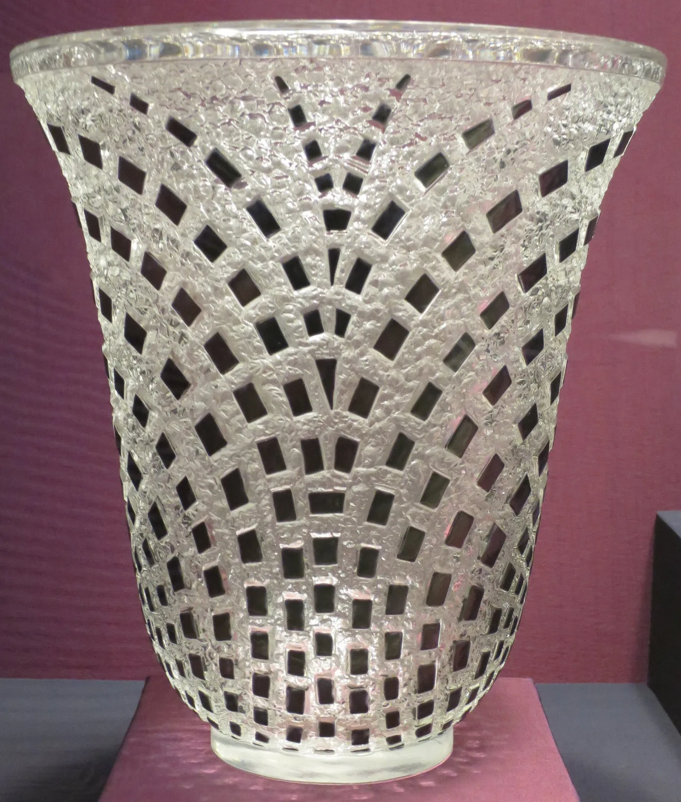 Clear glass vase with a raised lattice of small squares over a granular ground, flaring to a plain polished rim