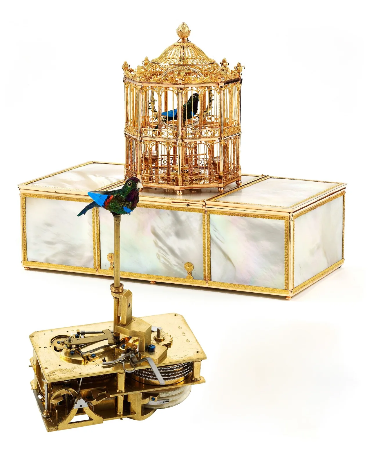 Mother-of-pearl and gold table box with a domed gilt cage on its lid holding a small feathered bird, shown above the box's mechanism removed and standing open on its baseplate with bellows, cams and a going barrel visible