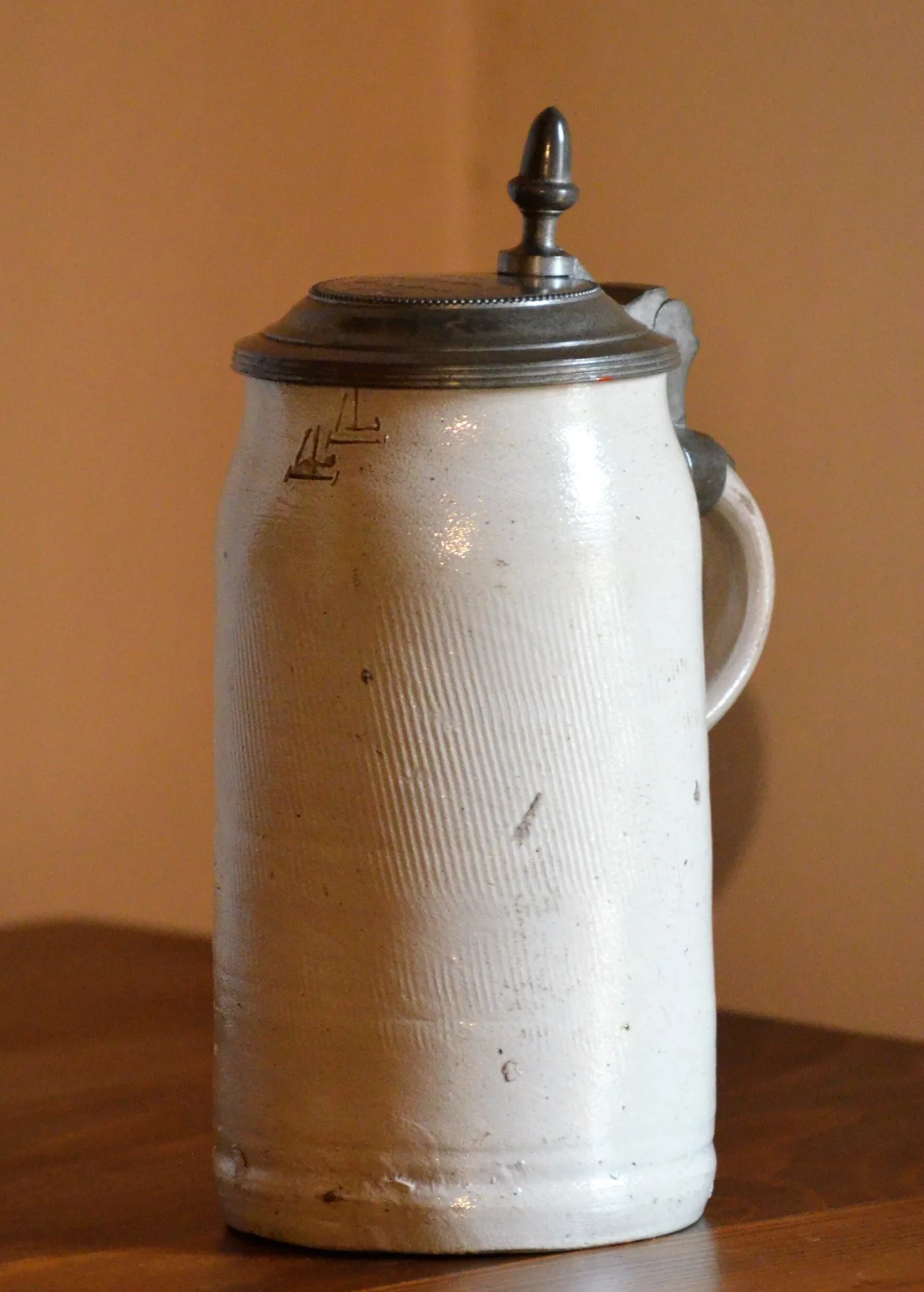 Plain grey salt-glazed stoneware beer mug with a hinged pewter lid and no decoration