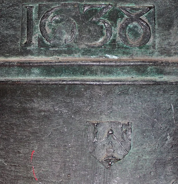 Close view of the shoulder of a bell showing raised cast lettering reading WHITECHAPEL BELL FOUNDRY between two moulding lines
