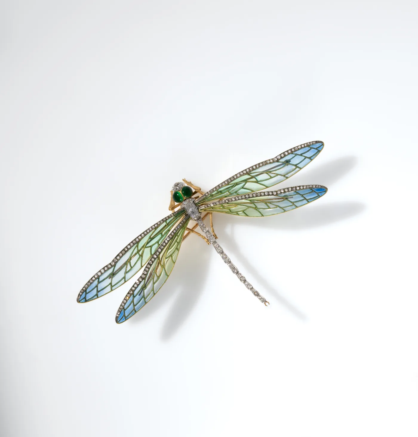 Dragonfly brooch with four long enamelled wings shading from blue to green, edged with small rose-cut diamonds, and green cabochon eyes