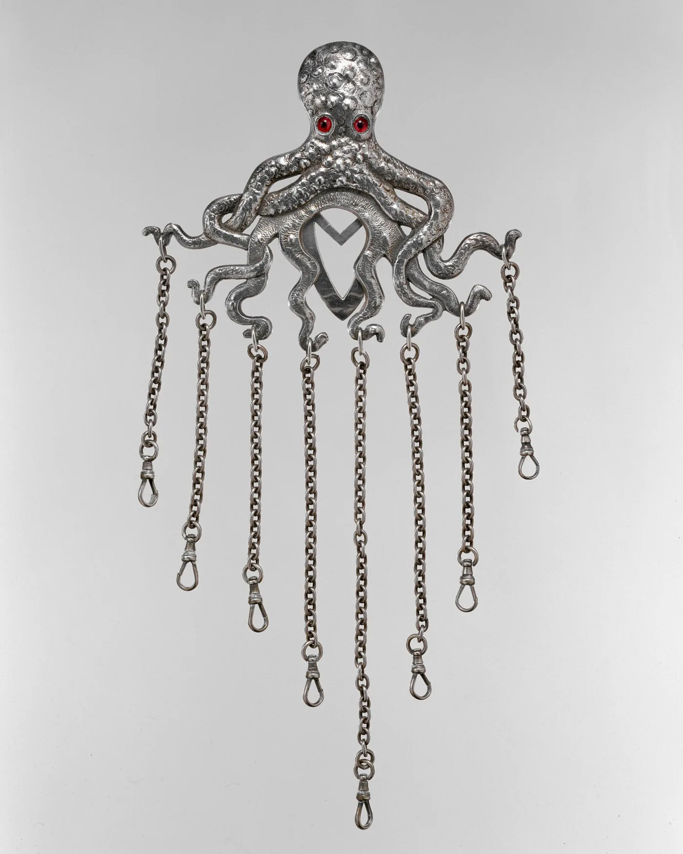 Sterling silver chatelaine cast as an octopus with red stone eyes, its eight chains ending in empty swivel clips