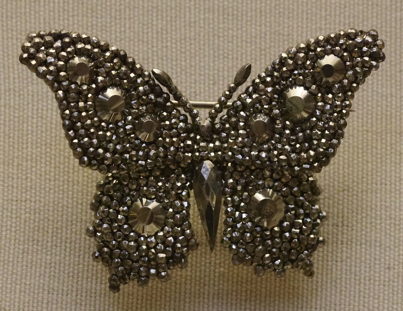 Cut steel butterfly ornament densely covered in small faceted steel studs of two sizes
