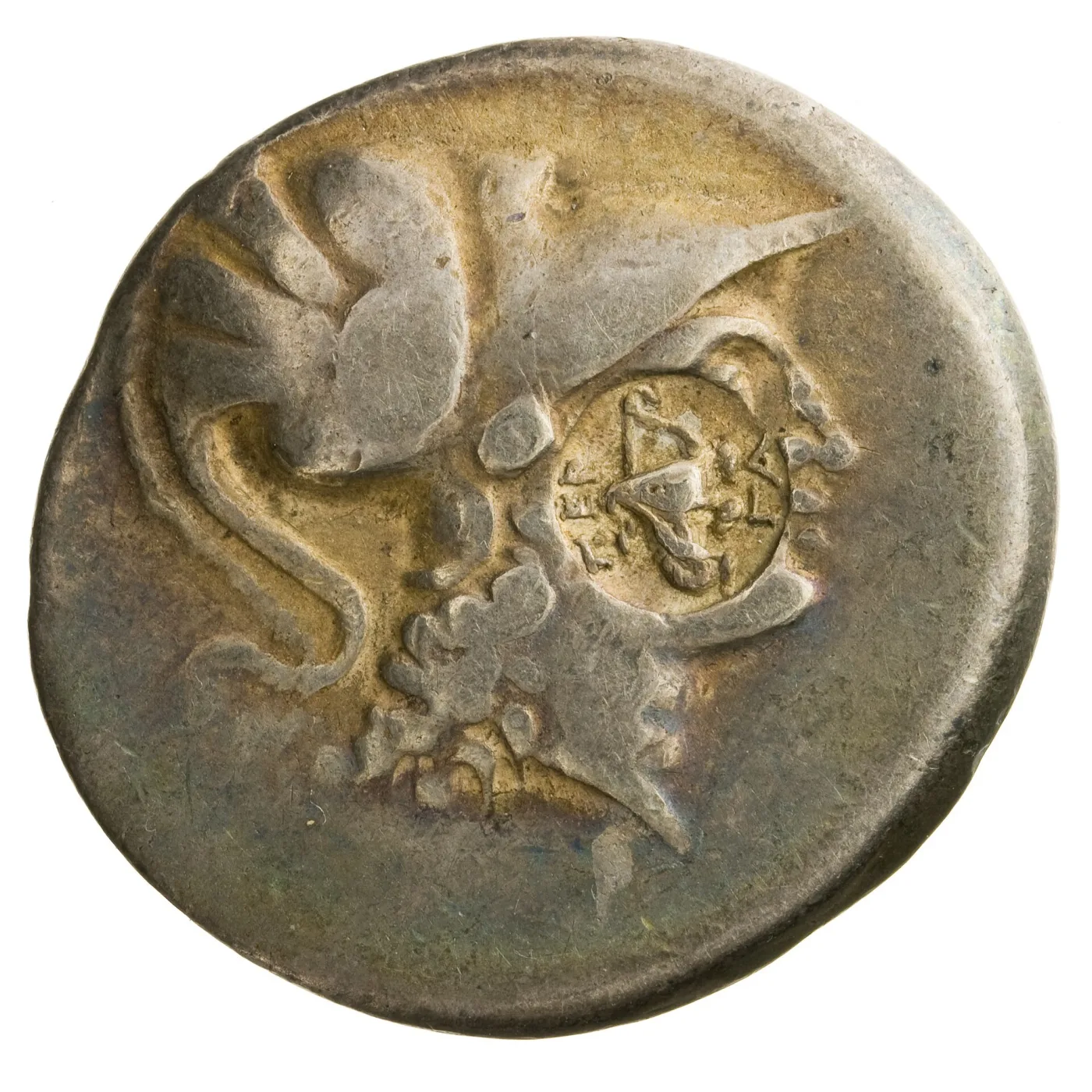 Large silver coin showing a helmeted head of Athena in profile, with a small oval punch mark stamped into the field over the design, containing a bow case and tiny lettering