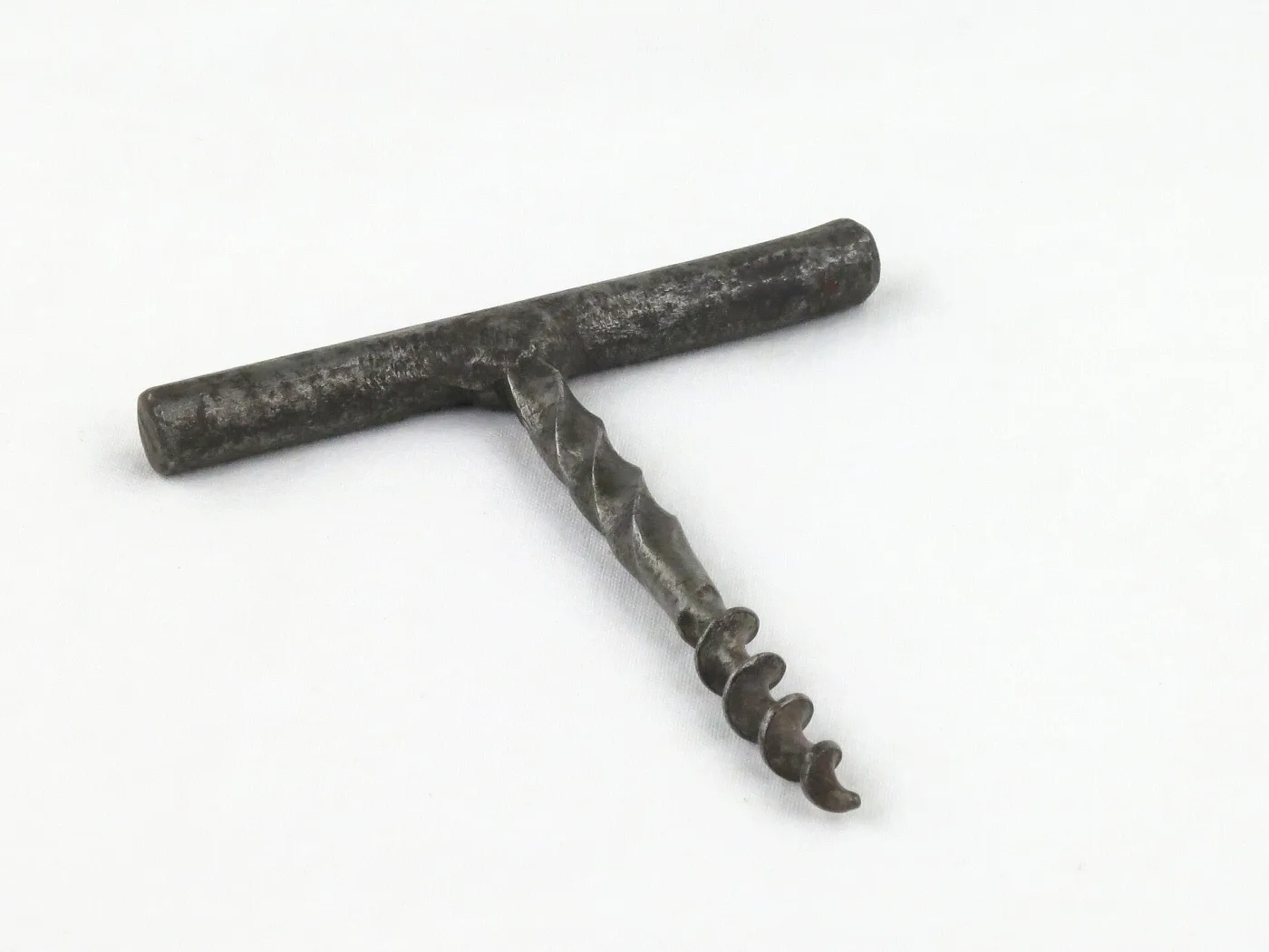 Hand-forged steel corkscrew whose T-bar, shank and flighted spiral appear to be worked from one piece of metal