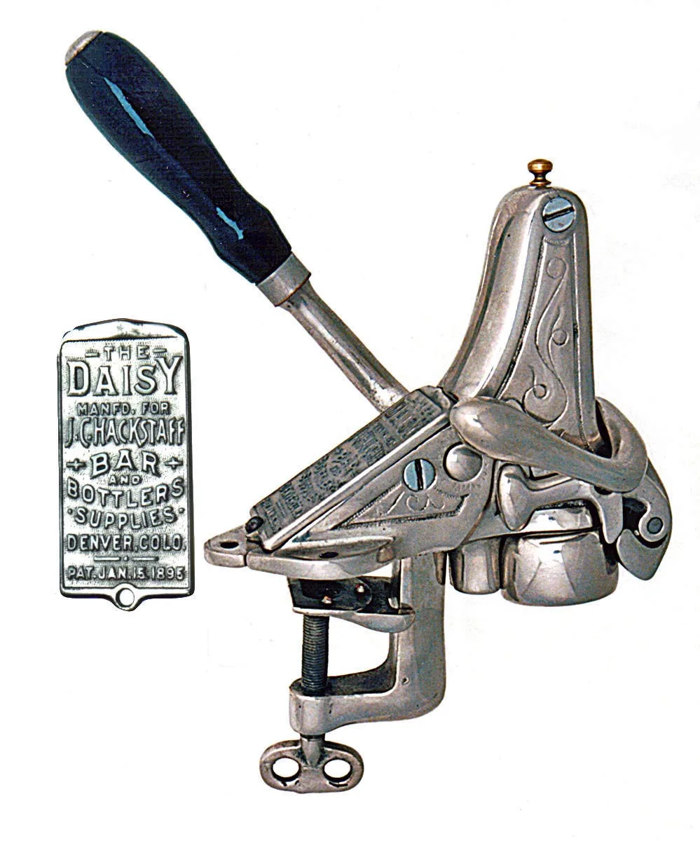 Bar-mounted cast corkscrew with a lever arm and a clamp foot, beside its cast plate reading The Daisy, manufactured for J.C. Hackstaff, bar and bottlers supplies, Denver, Colorado, patented January 15 1895