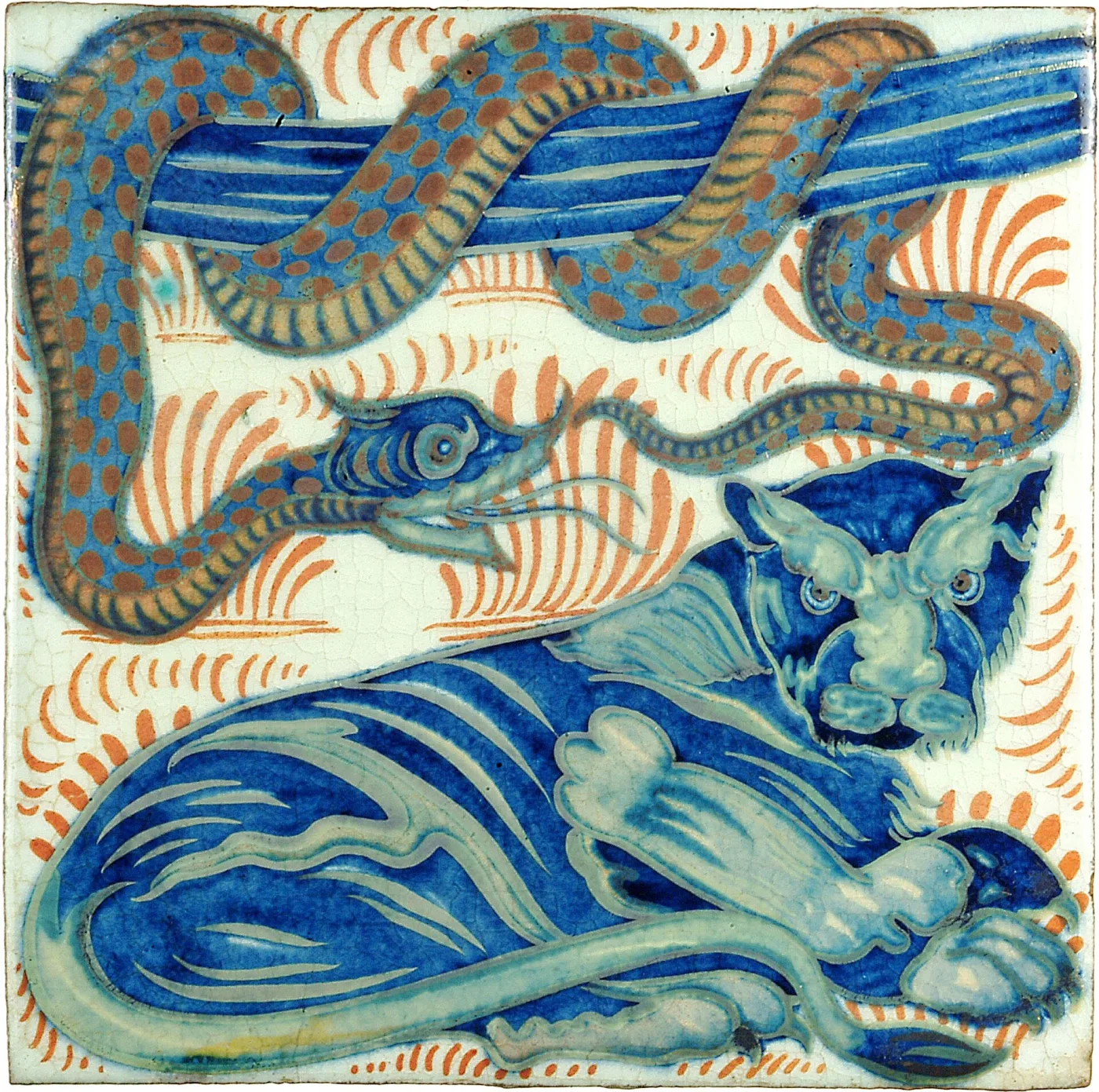 Square glazed tile painted with a long spotted serpent looping above a crouching long-tailed cat, in deep blue and turquoise with orange-red flame strokes on a crazed cream ground