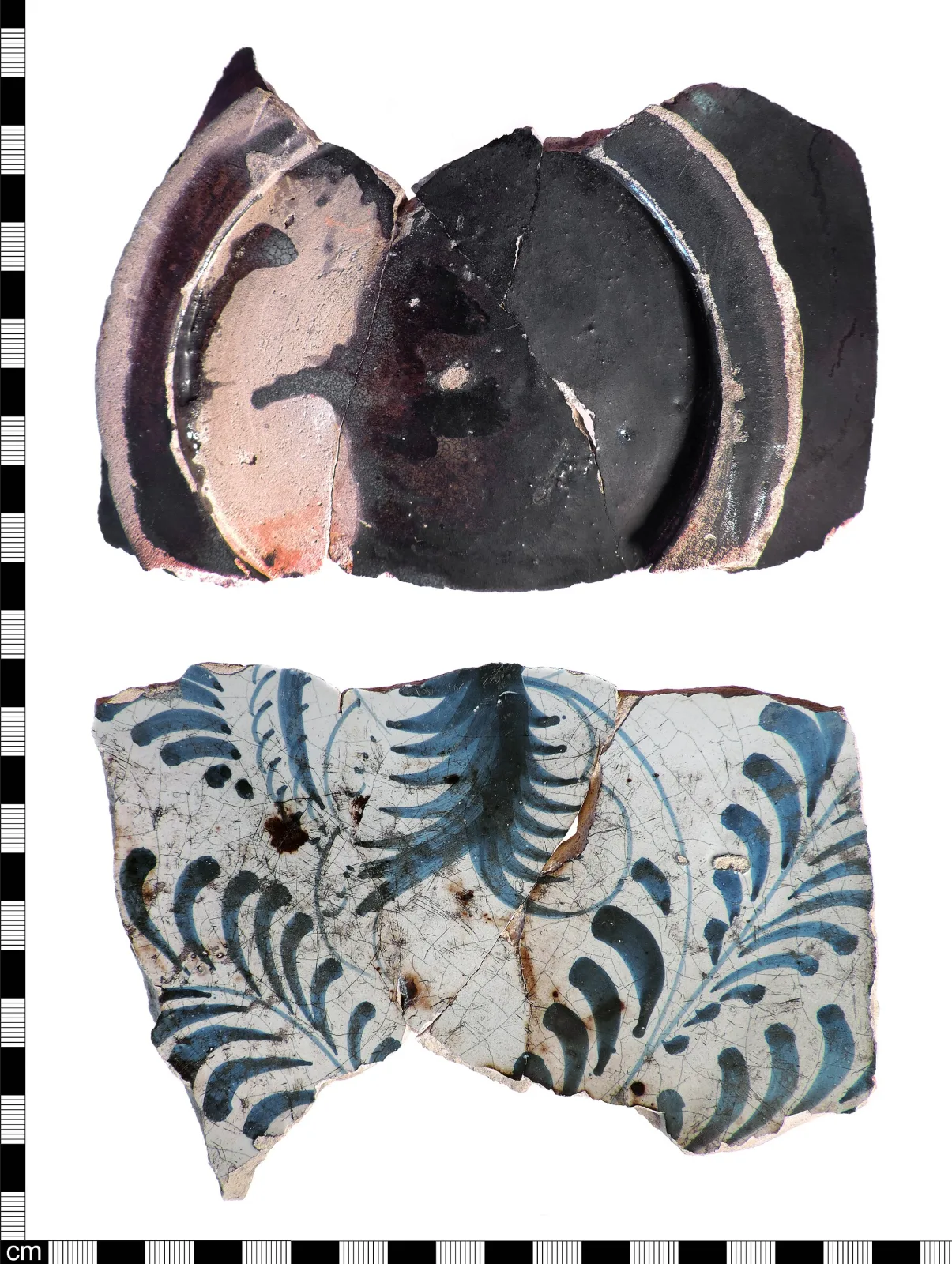 Two groups of broken pottery fragments against a centimetre scale: above, sherds seen edge-on so that a pale pink-buff clay core shows between white glaze layers on both faces; below, the same sherds seen face-on with blue painted foliage