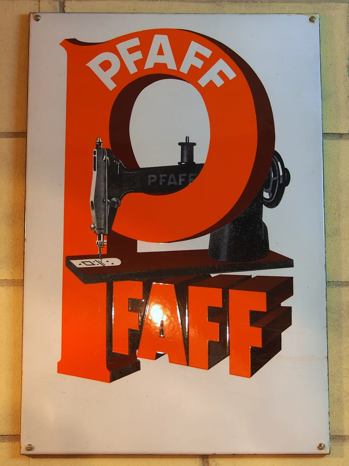 Enamel sign with a white ground carrying a huge orange letter P and the word PFAFF drawn in perspective as solid three-dimensional blocks, with a black sewing machine standing on the letterform