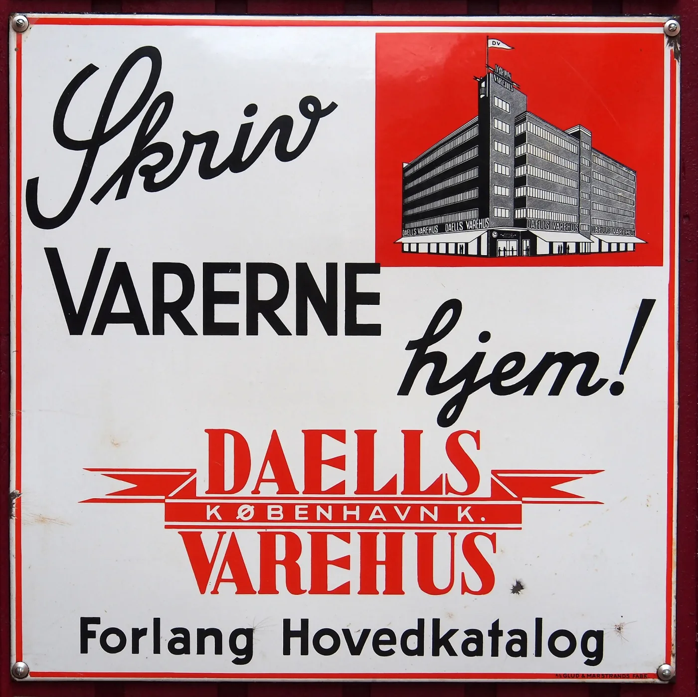 Enamel sign on a white ground with a red panel showing a department store building, lettered Skriv Varerne hjem, Daells Varehus, København K, Forlang Hovedkatalog
