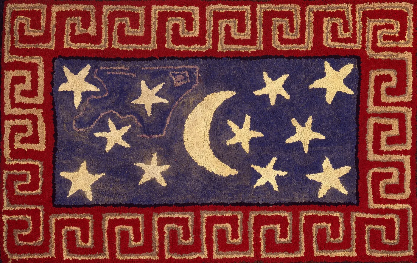 Hooked rug with a crescent moon and ten stars in cream on a dark blue field, framed by a red border worked with a cream Greek-key pattern