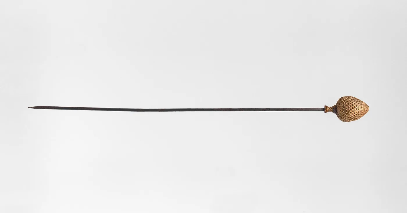 Long steel hat pin with a gold acorn-shaped head covered in fine granulated scale-work