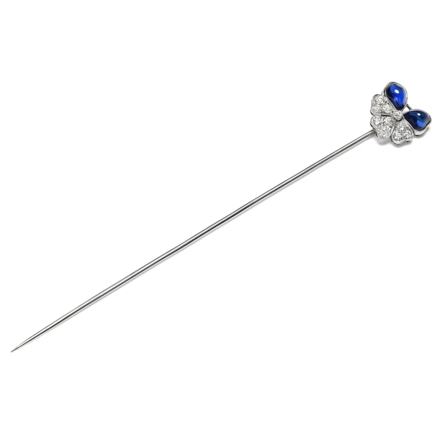 Hat pin with a four-petalled flower head, two petals of blue cabochon sapphire and two set with small pavé diamonds, on a long white metal shaft