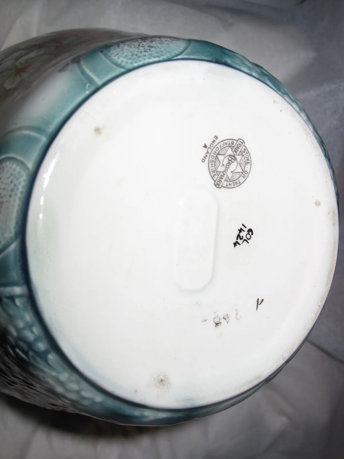 Underside of the same jardiniere showing a printed circular trade mark around a six-pointed star, reading Stoke on Trent, Staffordshire and England, with a partial firm name ending in Bros