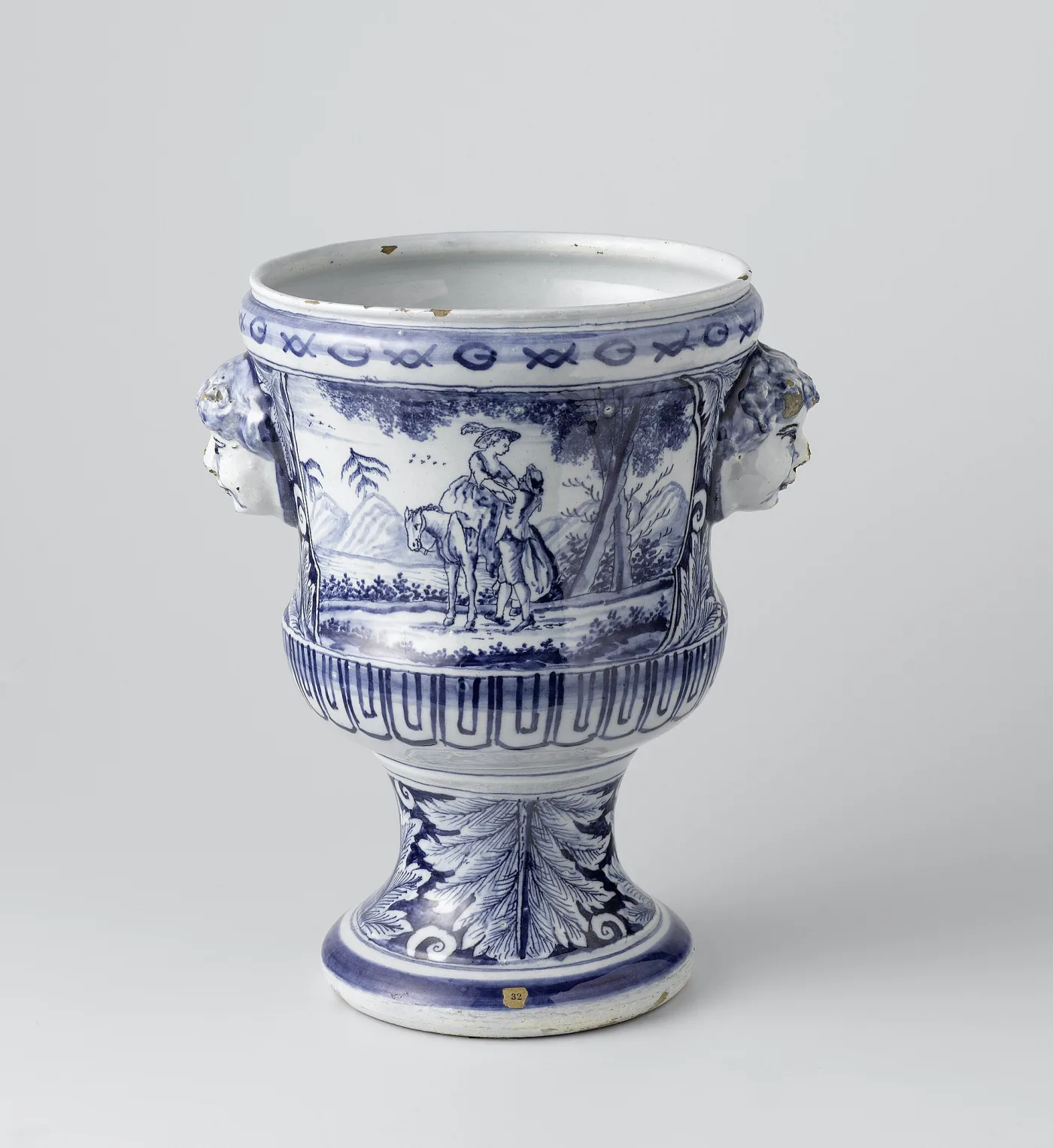 The companion cache pot of the same pair, identical in form and palette but painted with a rider on horseback, and with chipping visible along the rim