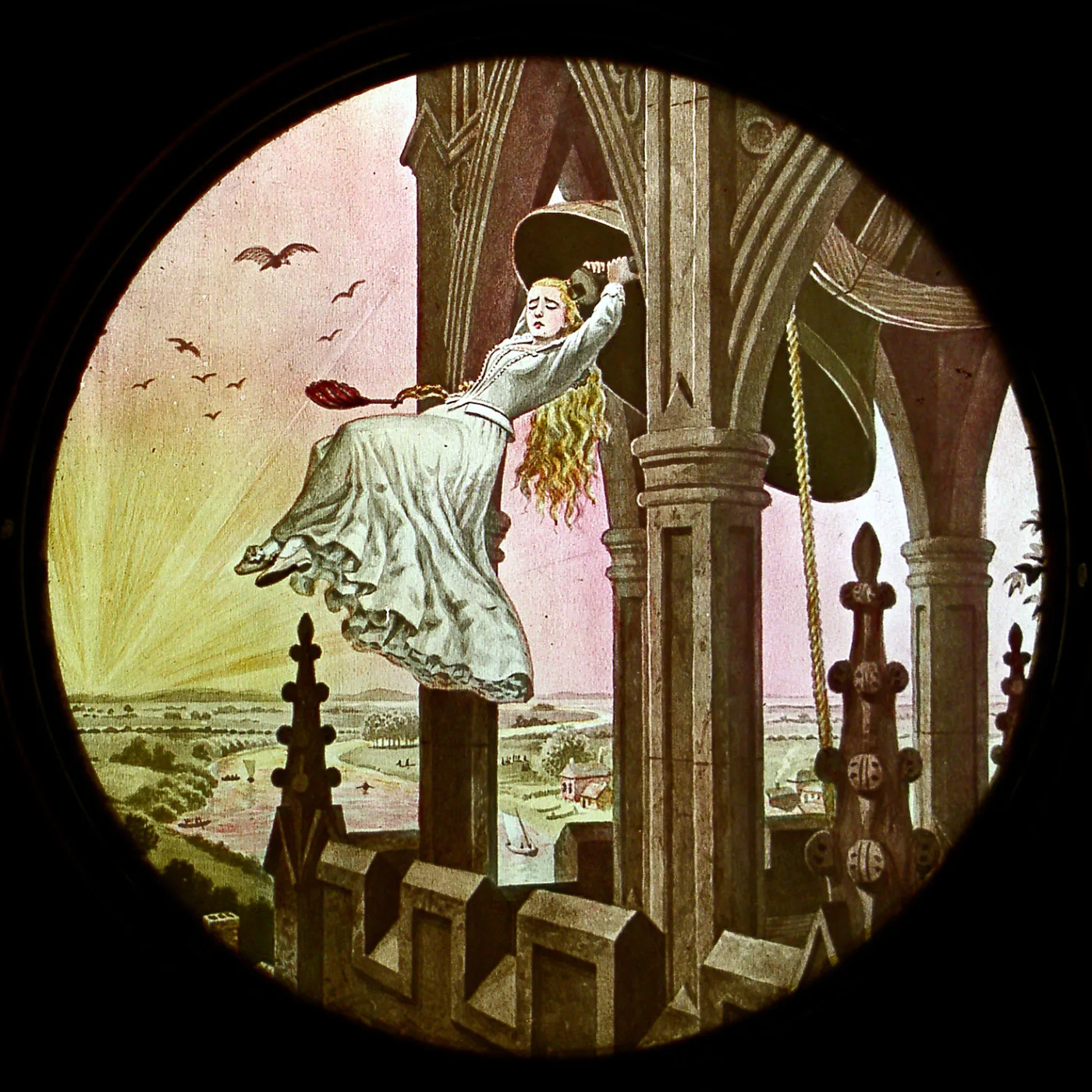 Circular lantern-slide image of a woman in flowing white robes standing on a parapet with arms raised against a pink and yellow dawn sky, birds flying above a distant town