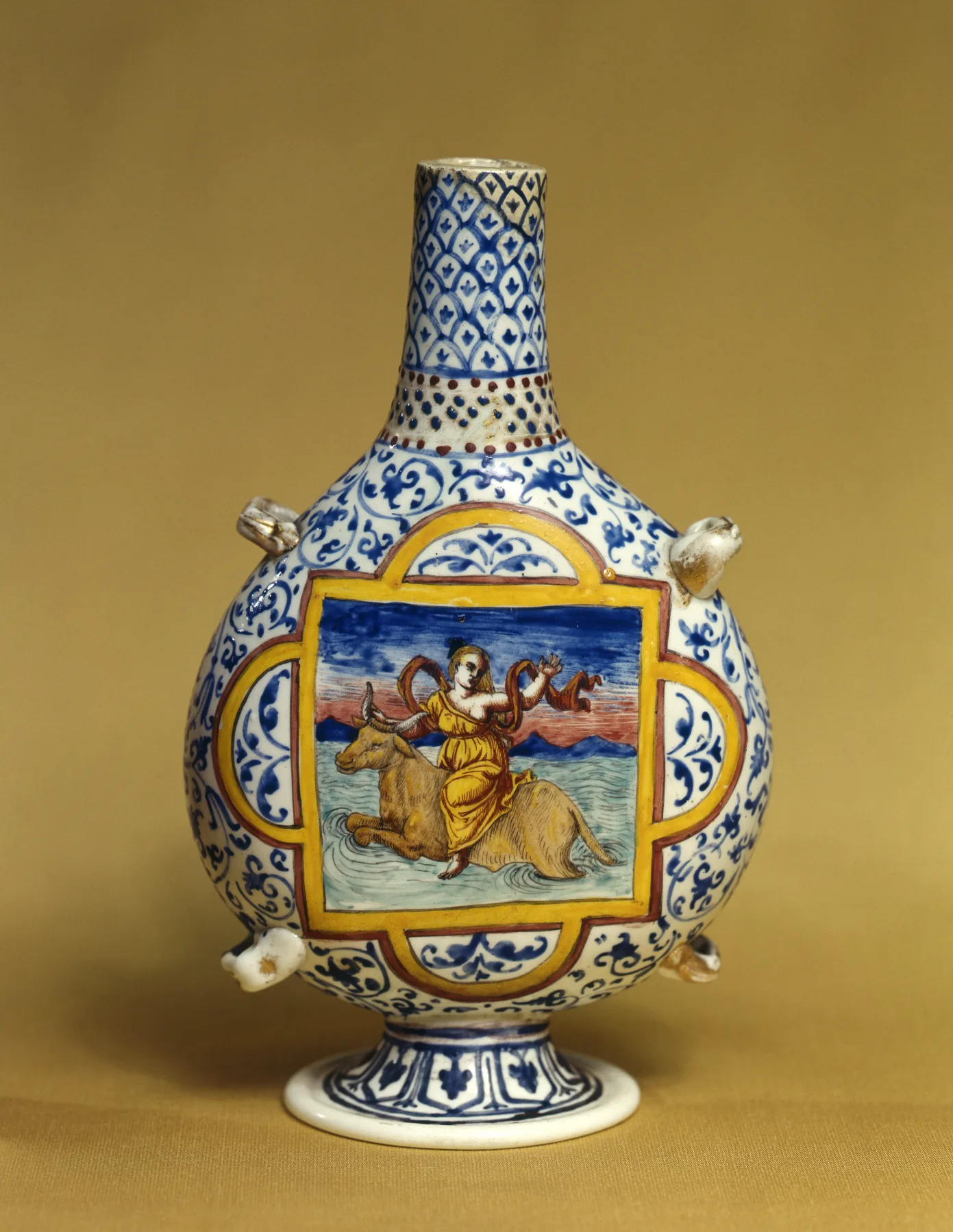 White glass pilgrim flask painted in blue and yellow with a woman riding a bull through water