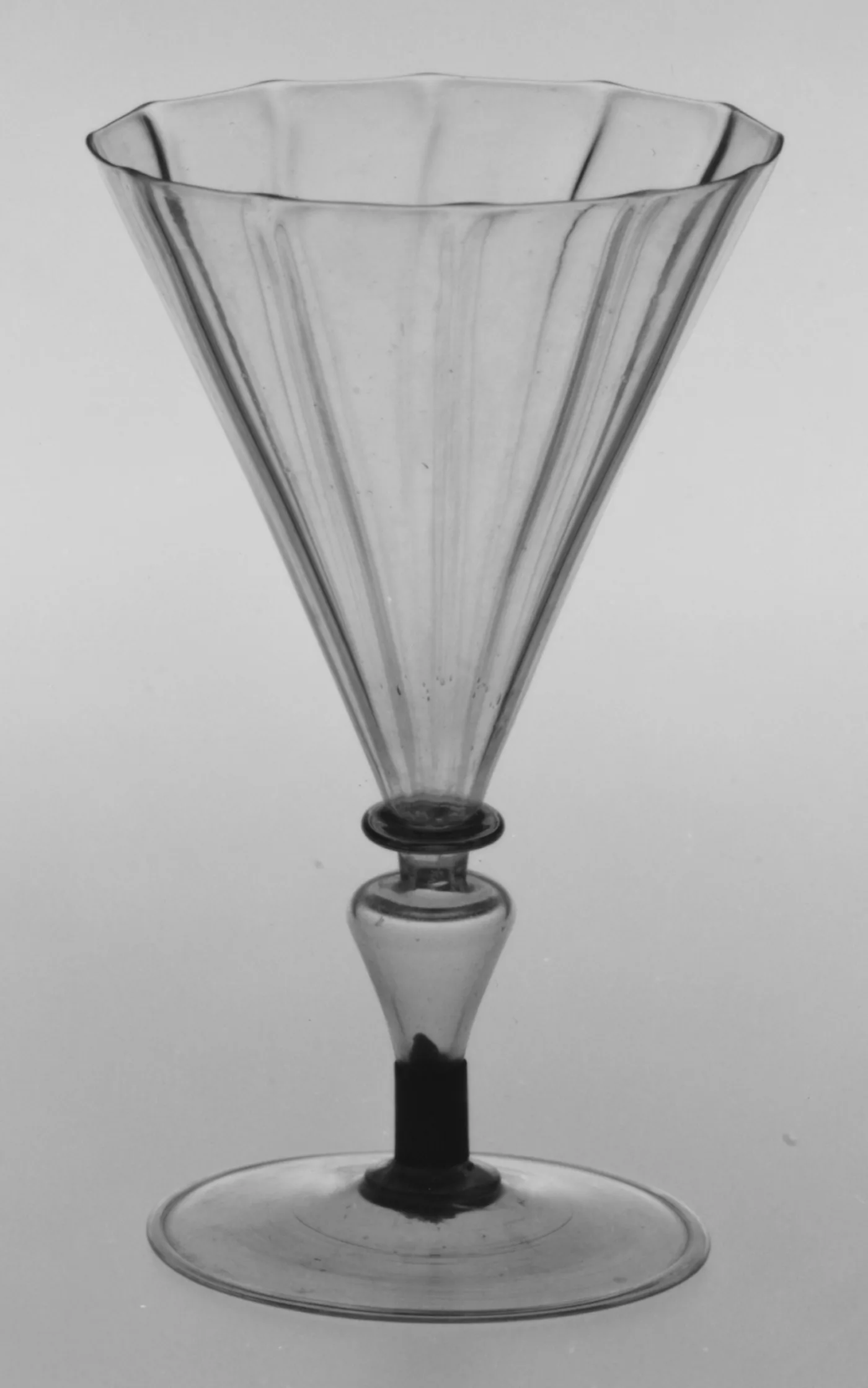 Colourless conical goblet on a knopped stem, catalogued as probably façon de Venise from northern Europe