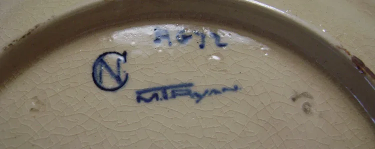 Curved unglazed base of a pot painted in blue with an N inside a C monogram, beside a cursive decorator's signature and small impressed numbers
