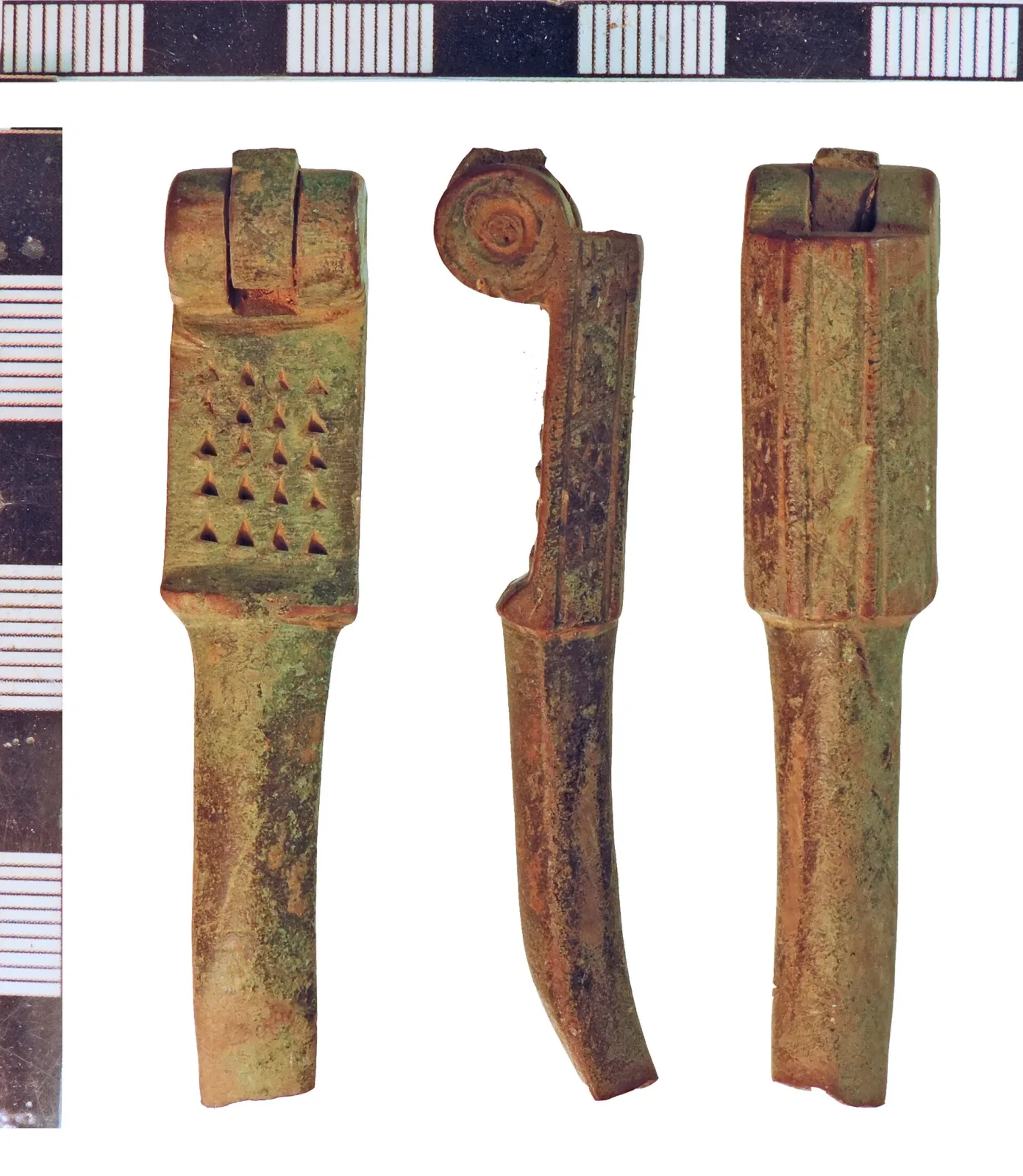 Three close views of a broken copper-alloy nutcracker head showing four rows of V-shaped punched indentations, the pivot lugs on their axis bar, and the fresh break across the handle