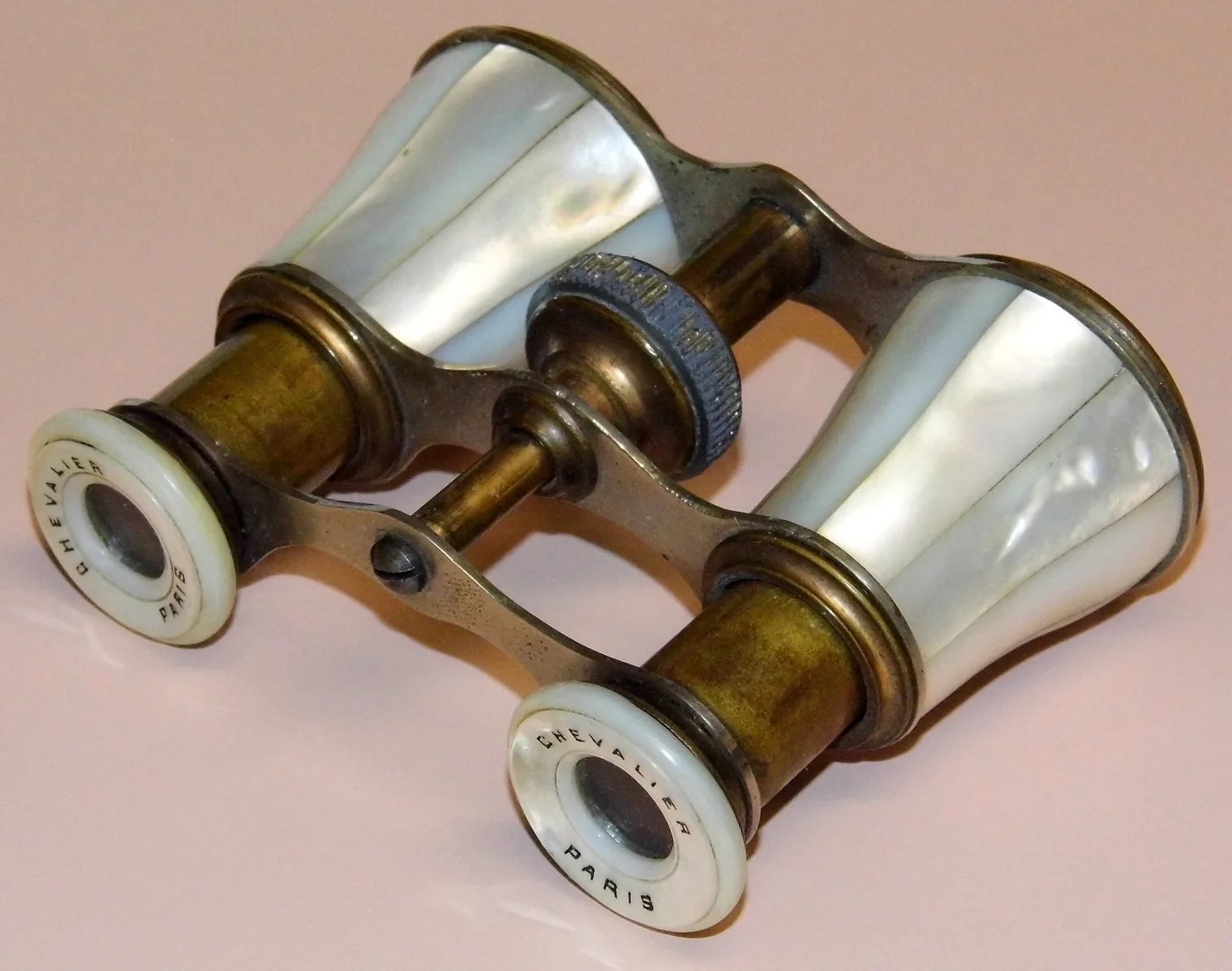 Mother-of-pearl opera glasses with browned brass fittings, the eyepiece rims lettered CHEVALIER PARIS