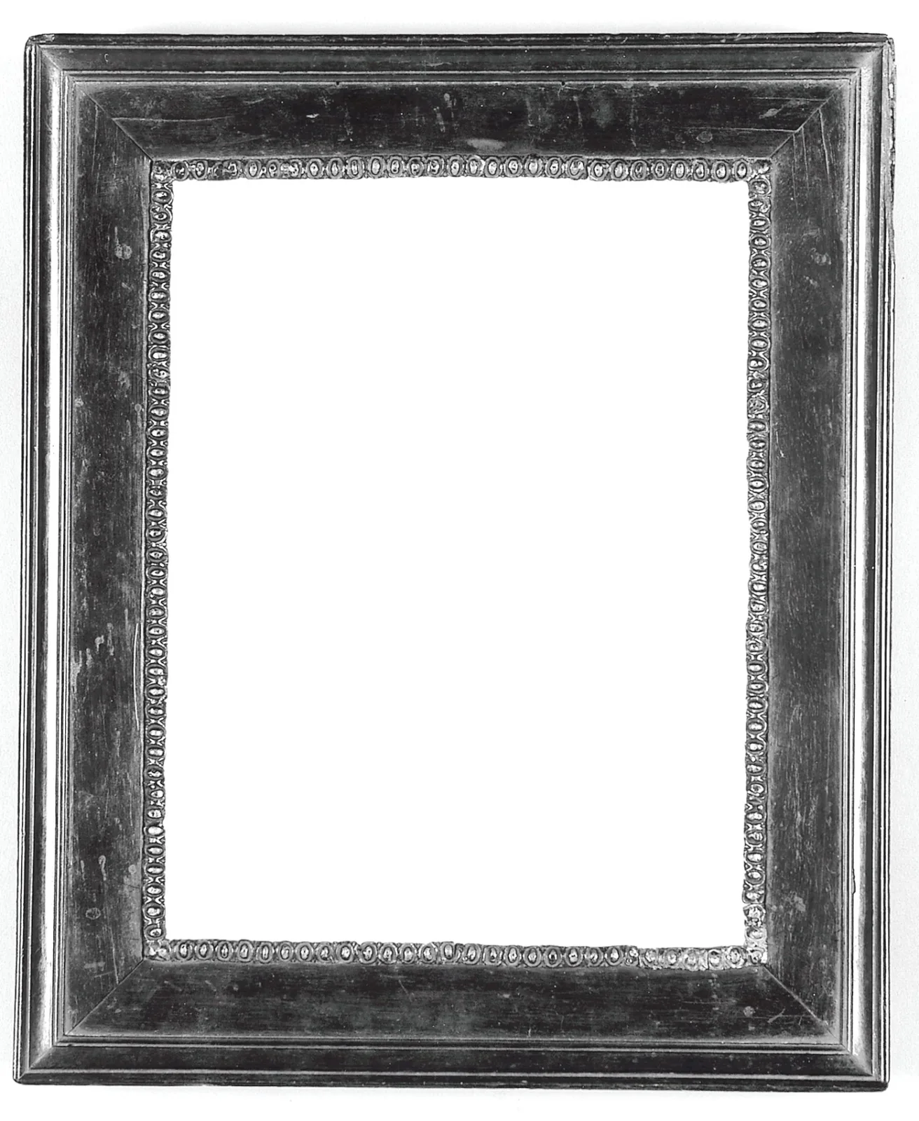 Plain cassetta picture frame photographed in black and white, a wide flat panel between a raised outer moulding and a narrow beaded inner edge, with no carved ornament