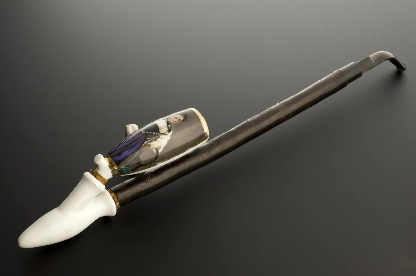 German pipe with a white porcelain bowl painted with a woman's portrait, gilt mounts and a long horn stem