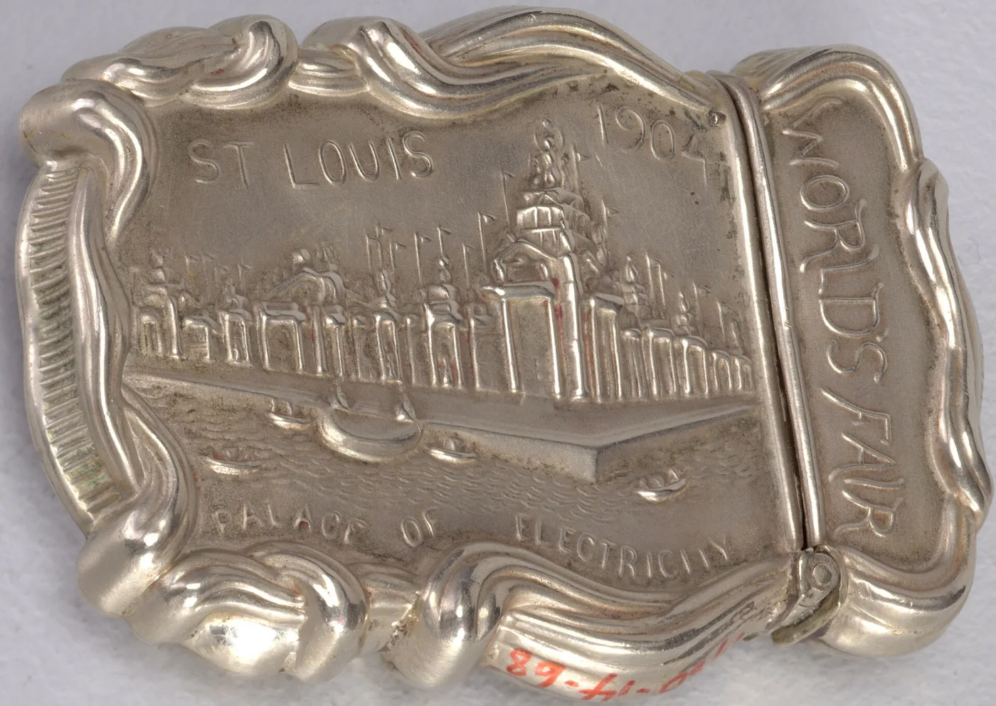Silver matchsafe stamped in relief with a domed exhibition building, lettered St Louis 1904 World's Fair Palace of Electricity