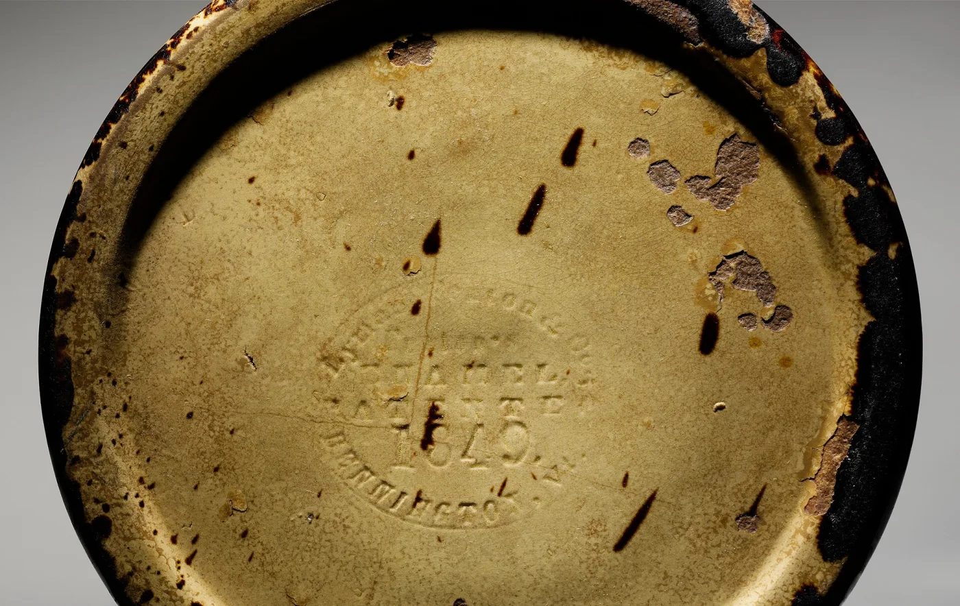 Underside of the same jar showing an oval impressed pottery mark reading Fenton's Enamel Patented 1849 Bennington Vt