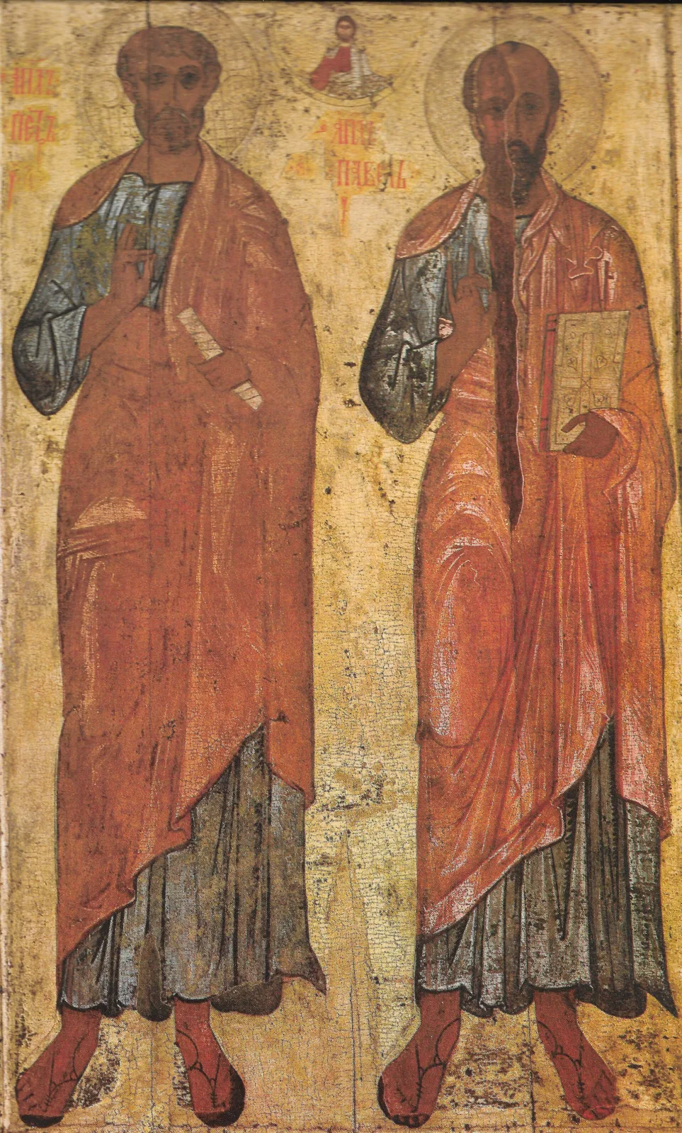 Tall narrow icon showing the apostles Peter and Paul standing side by side in pale robes against a worn gold ground, with a small figure of Christ between their heads