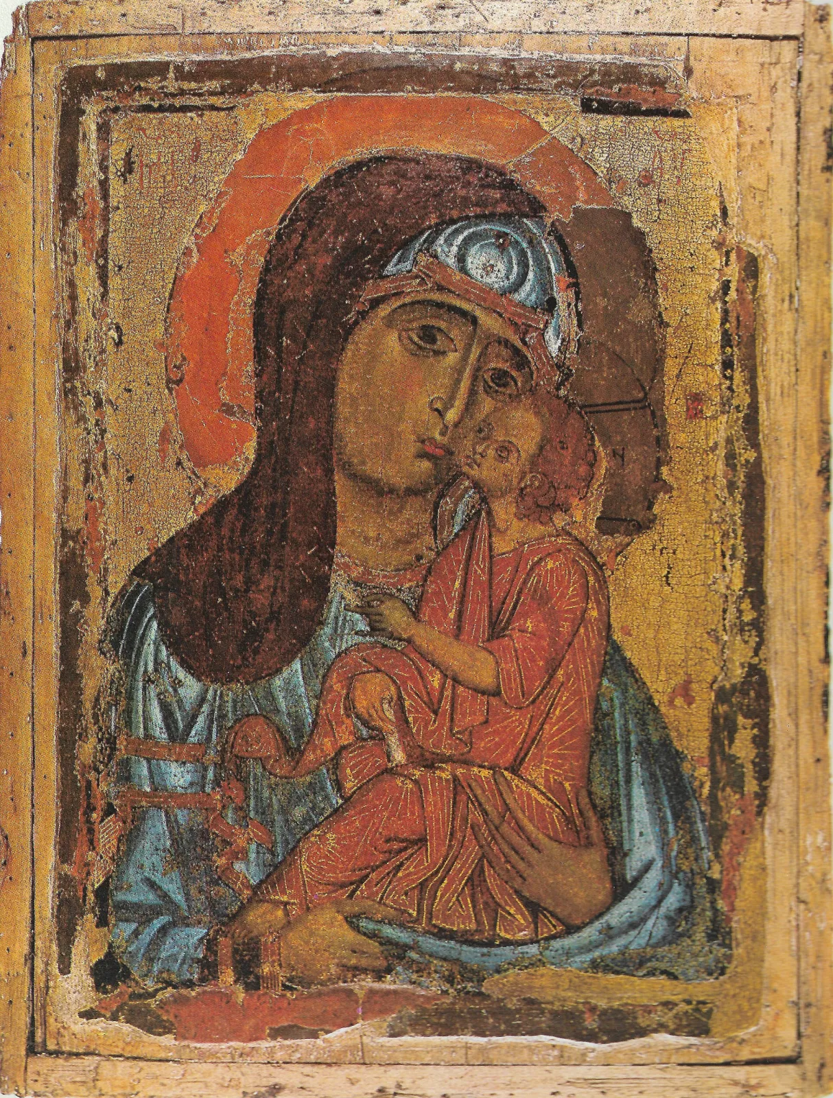Icon of the Virgin holding the Christ child cheek to cheek against a worn gold ground, the paint surface crazed and lost in places down to the wooden panel