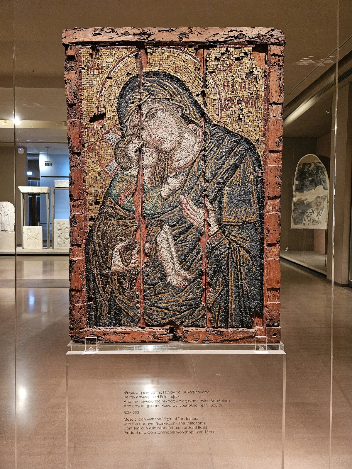 Byzantine icon of the Virgin and Child made entirely of tiny mosaic tesserae set into a wooden panel, displayed upright in a museum gallery