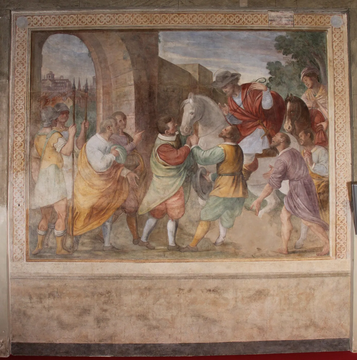 The same wall painting after conservation, colours recovered, the quatrefoil border continuous again and the dado beneath reading as one even surface