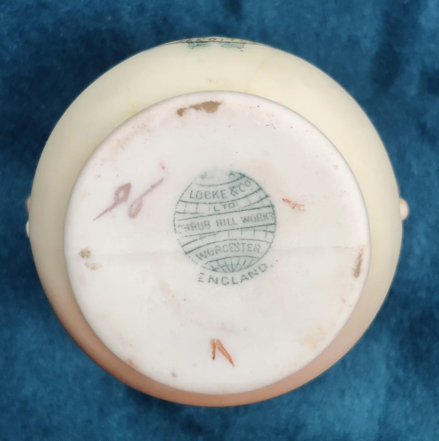 Underside of the same vase showing a green printed globe mark reading Locke and Co Ltd, Shrub Hill Works, Worcester, England