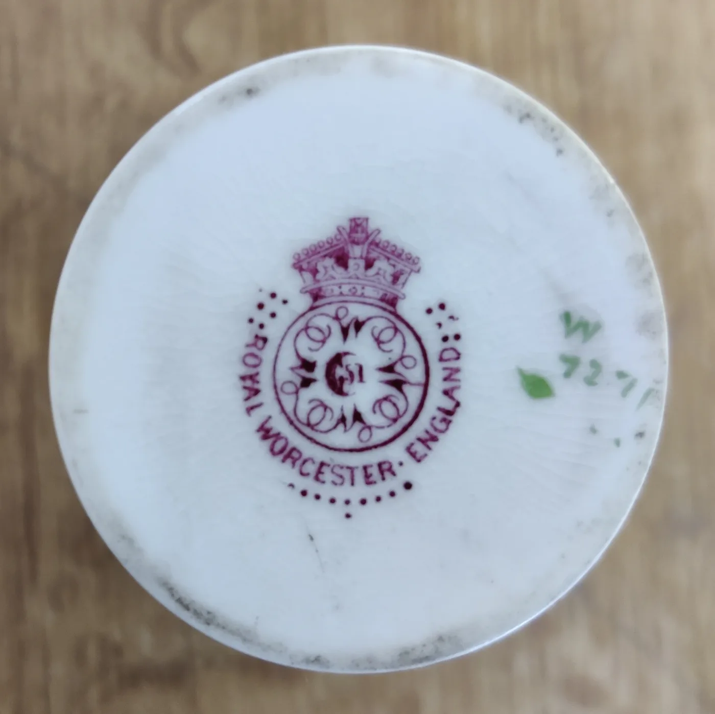 Underside of a coffee pot showing a puce printed crown and circle mark reading Royal Worcester England, ringed by small dots, with a green painted number to one side