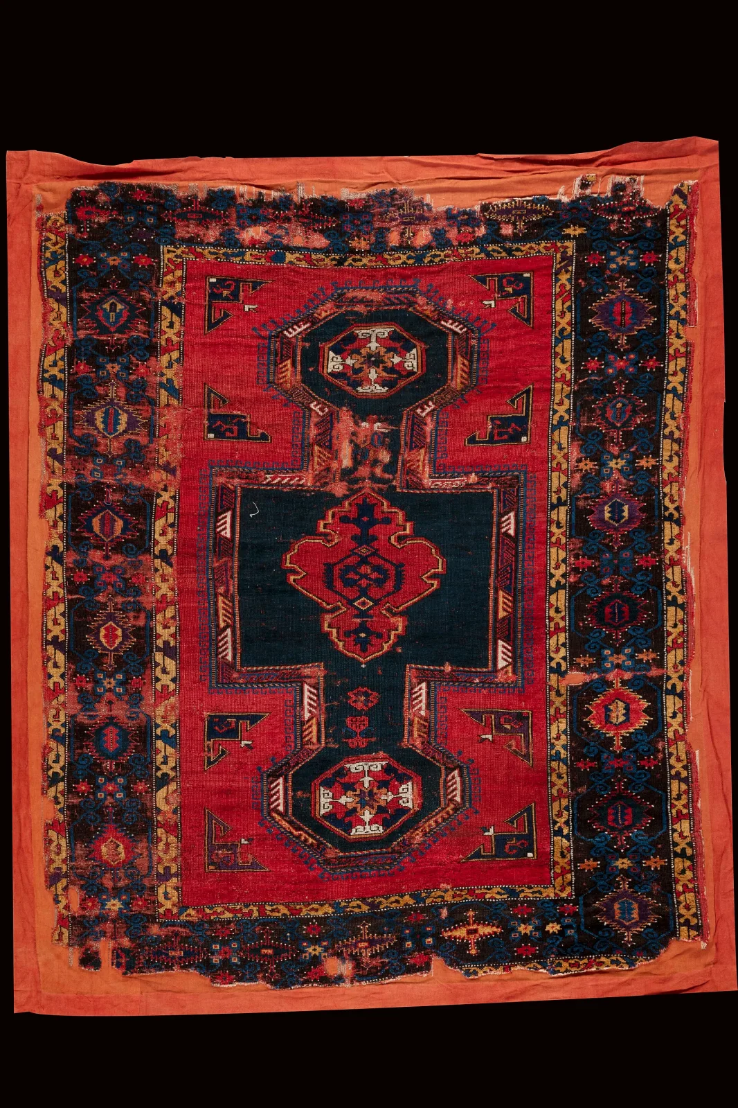 Ottoman prayer rug of the seventeenth century of Bellini type, with a red field, a stepped niche and a keyhole shaped re-entrant panel at the lower end