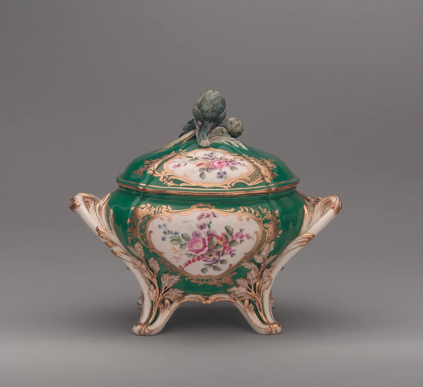 Sèvres tureen with an apple-green ground, rococo gilt cartouches enclosing painted flowers, and an artichoke finial on the cover