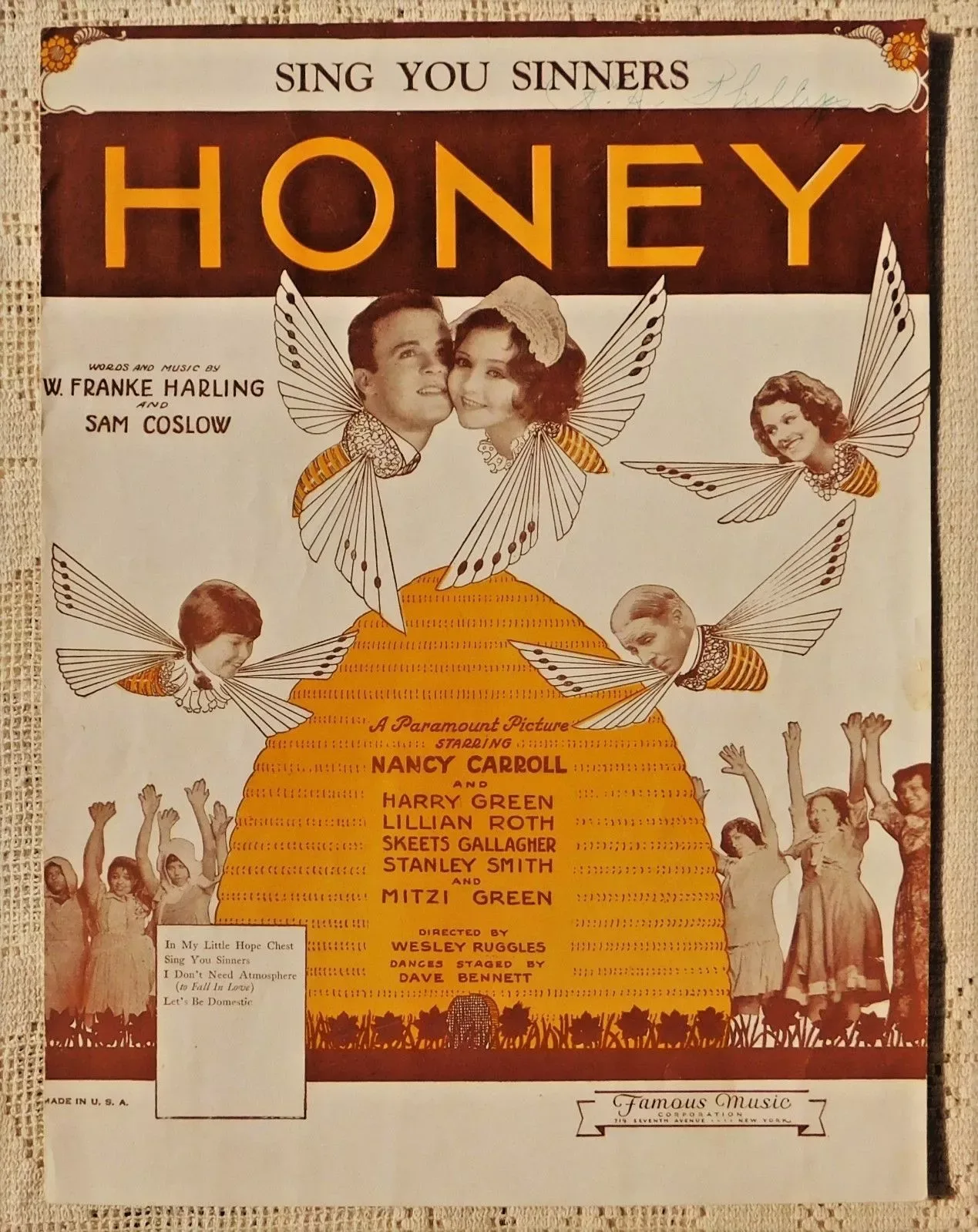 Sheet music cover in orange and brown showing three singers' heads above a crowd of winged figures, with the film title Sing You Sinners above the song title Honey