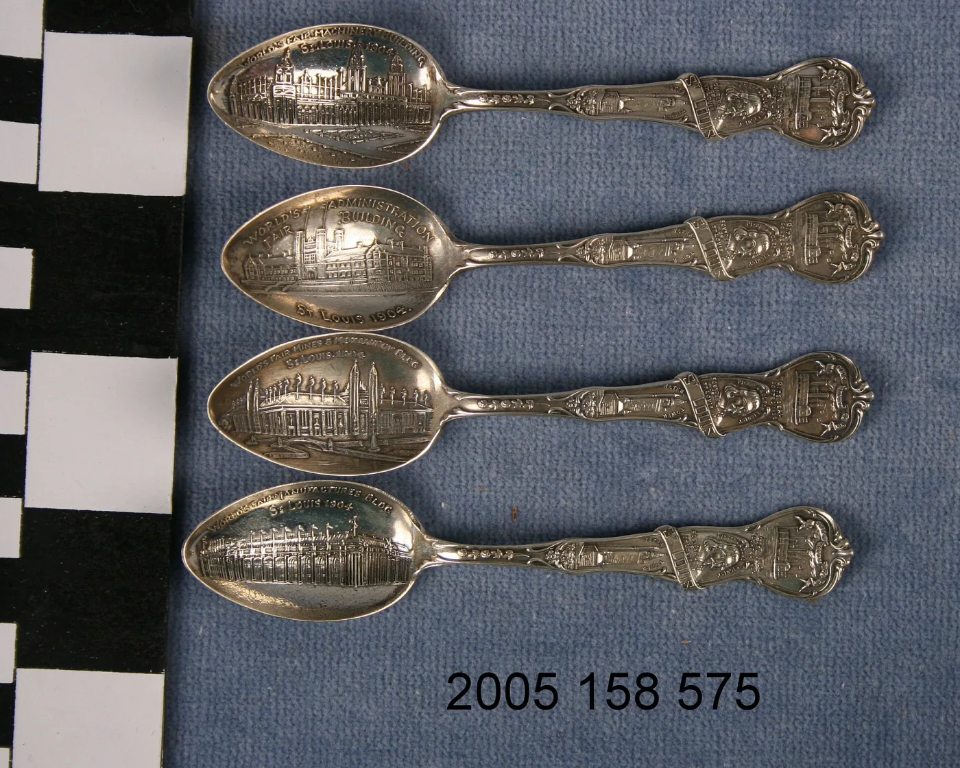 Four 1904 St. Louis World's Fair souvenir spoons with four different exposition buildings embossed in their bowls and identical handles