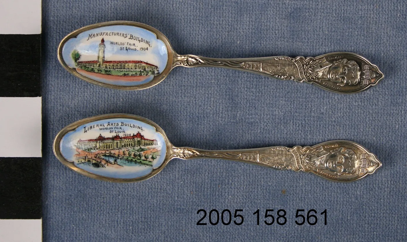 Two souvenir spoons with colour-enamelled bowl scenes of exposition buildings and portrait-bust handles