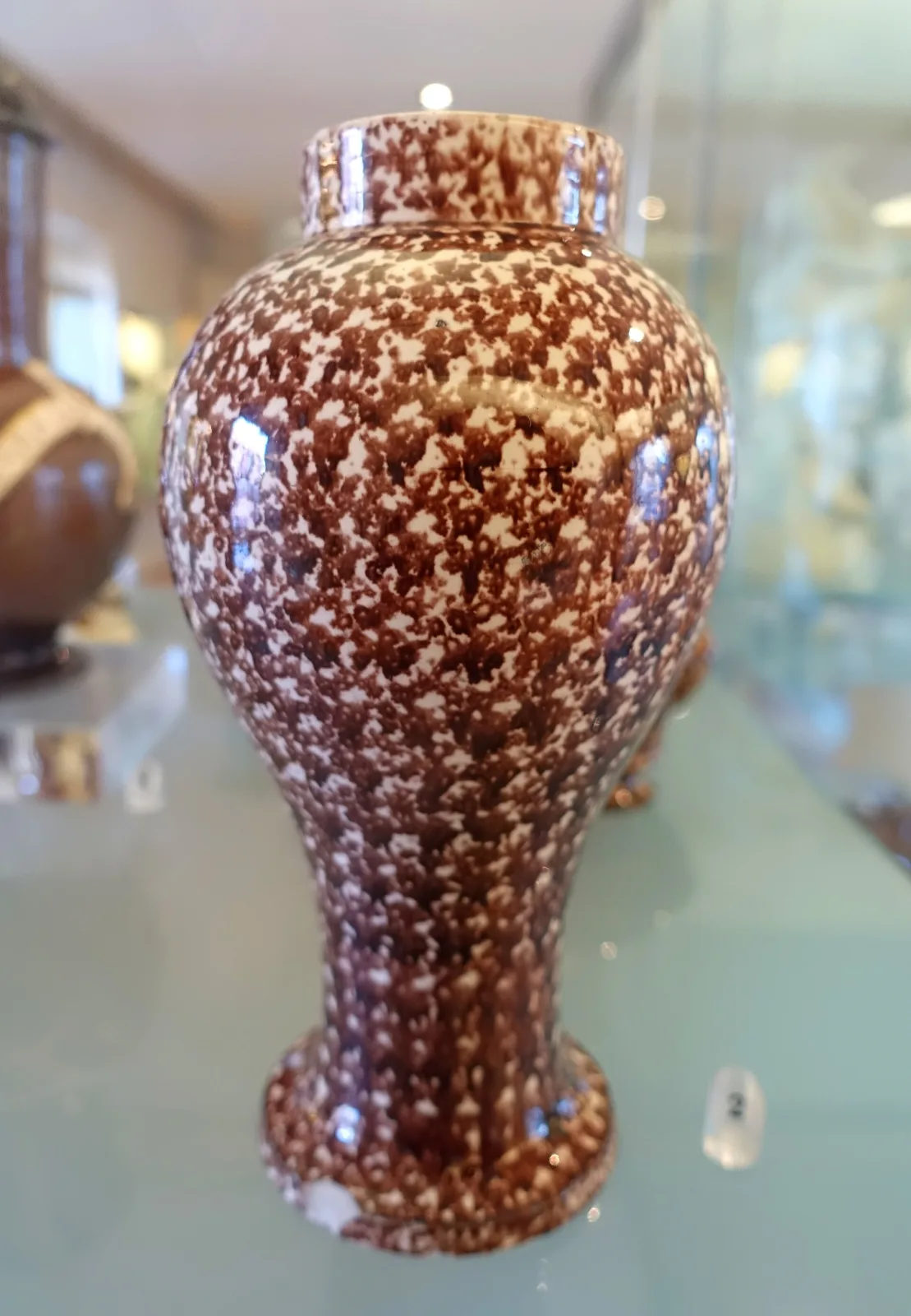 Baluster vase covered overall in a fine brown speckle over a cream body, dated about 1790 to 1860, from the Fábrica de Cavaquinho