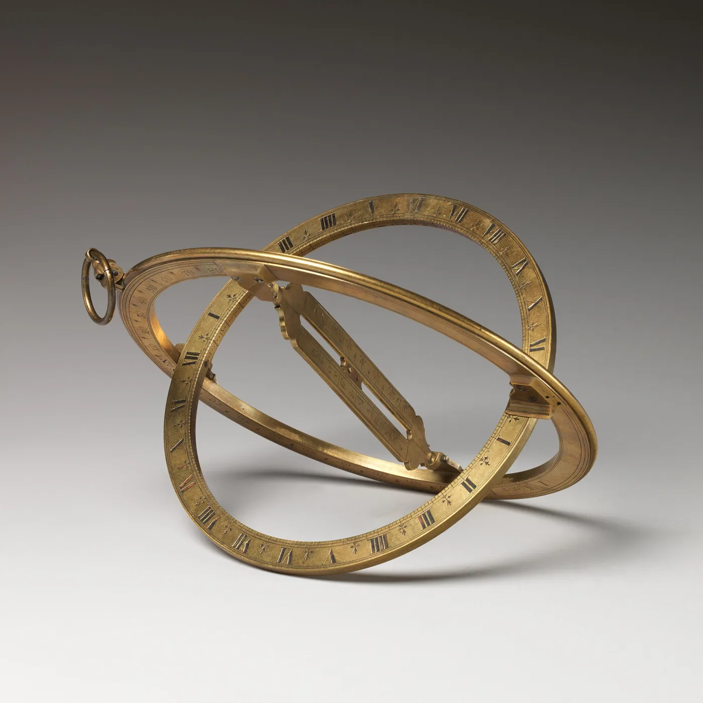 Brass universal equinoctial ring dial opened out, two graduated rings hinged at right angles with a pierced central bridge and a suspension shackle