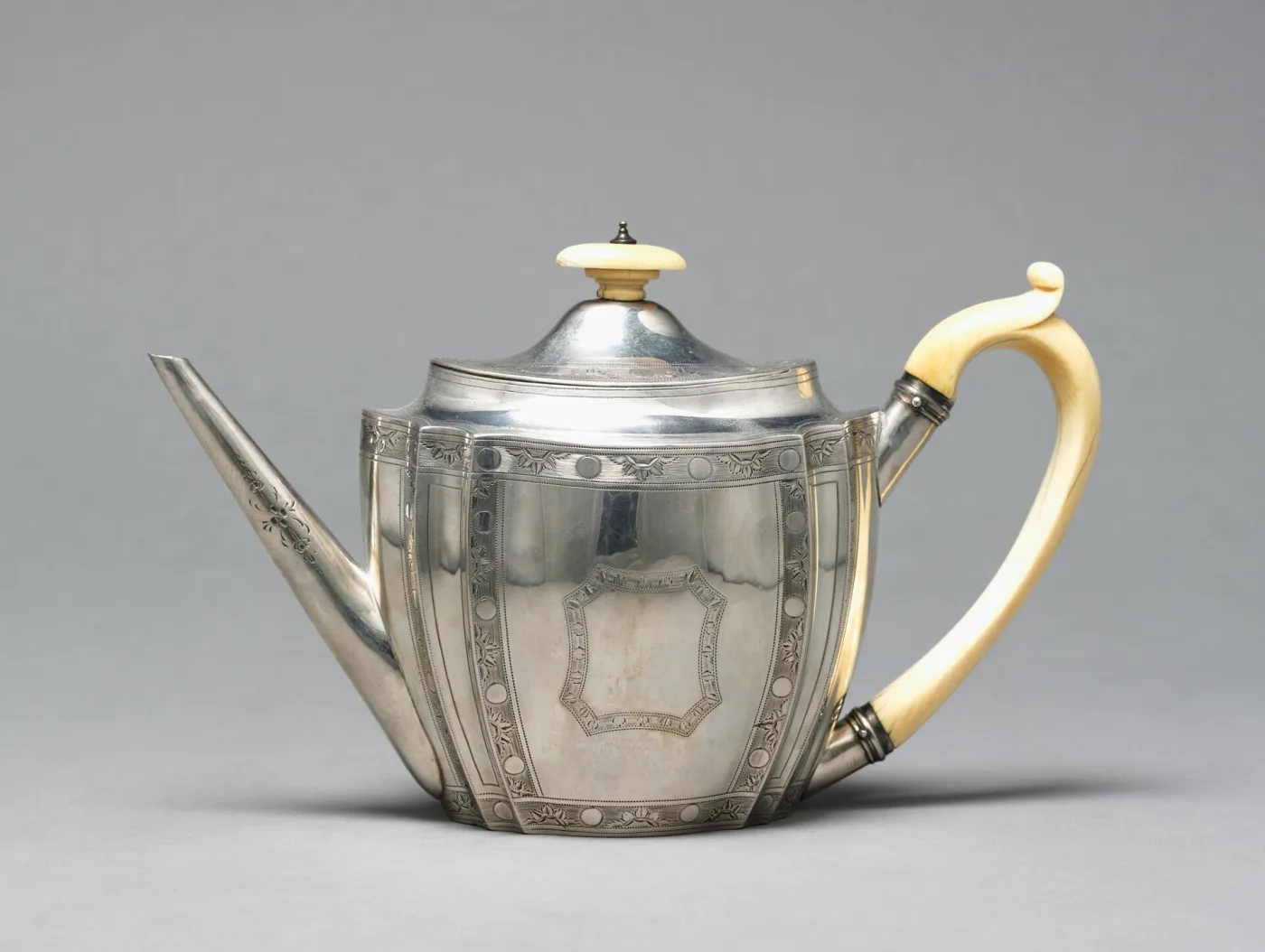 Straight-sided fluted silver teapot of 1795 by Thomas Hayter with an ivory handle and finial