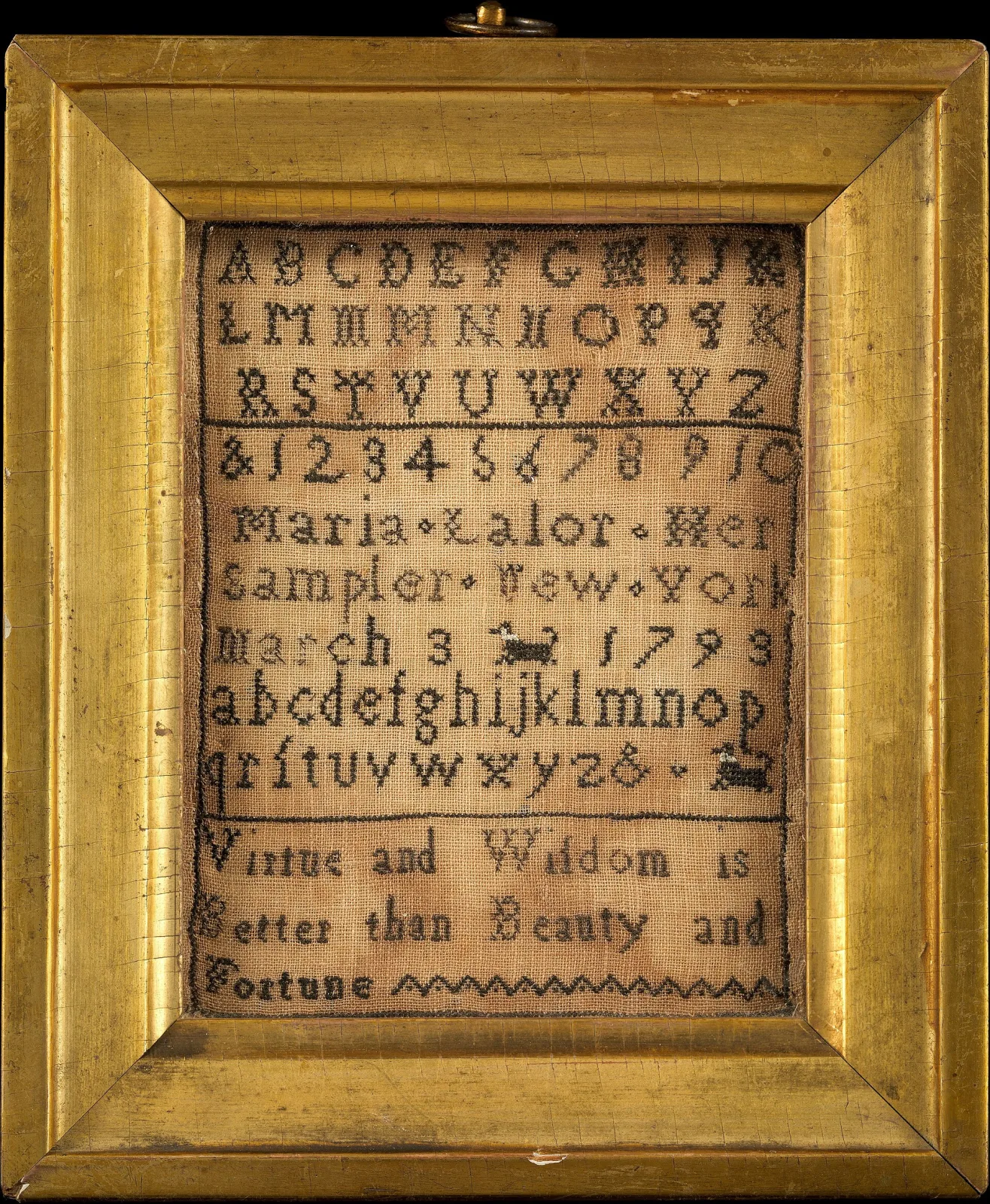 Framed embroidered sampler of 1793 worked with alphabets in upper and lower case, numerals, a verse, the maker's name and date, and a lower band of trees, animals and a fenced house