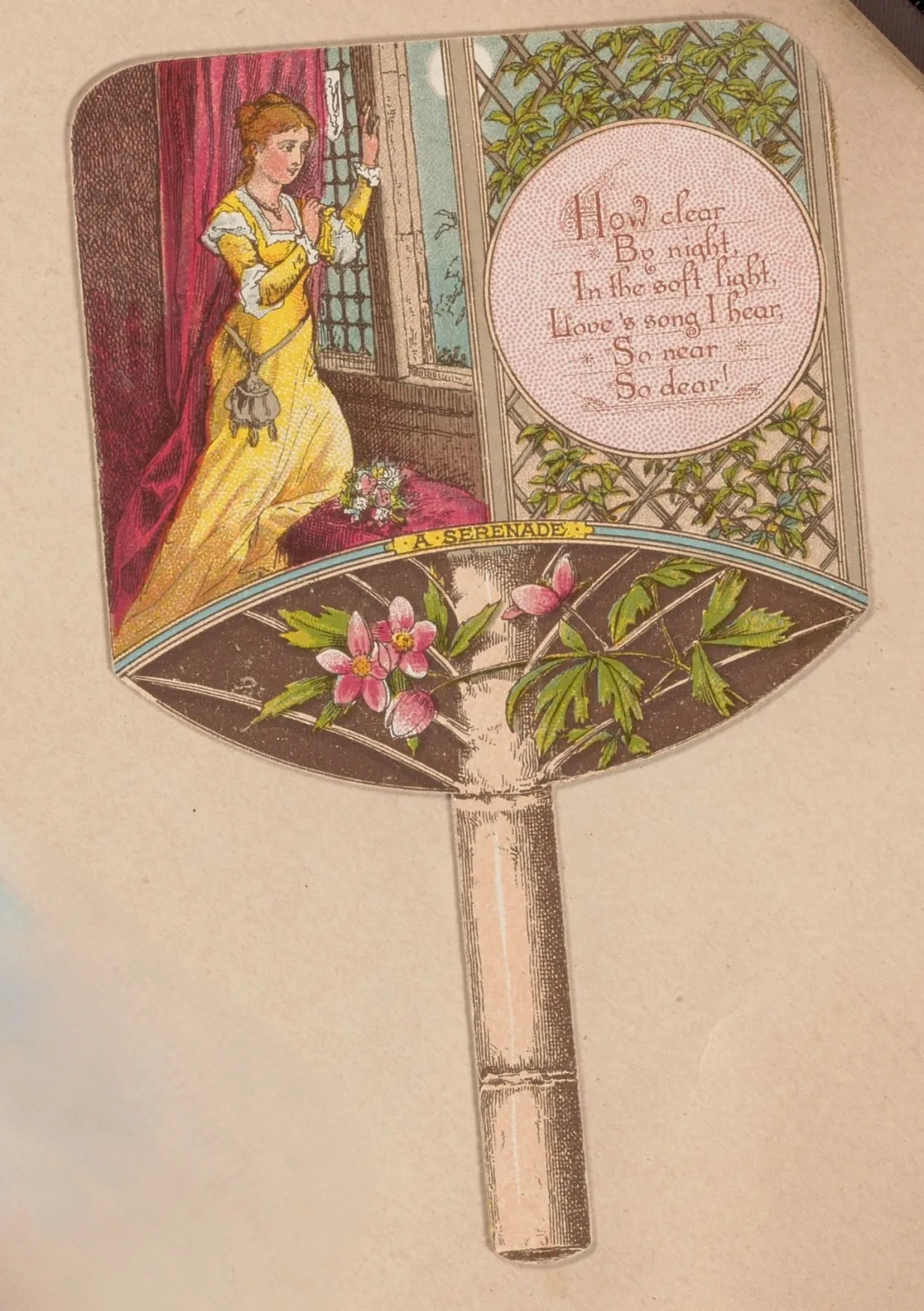 Advertising card cut to the outline of a folding hand fan, printed with a woman in a yellow dress at a window inside a border of pink blossom, the handle formed by the shaped card
