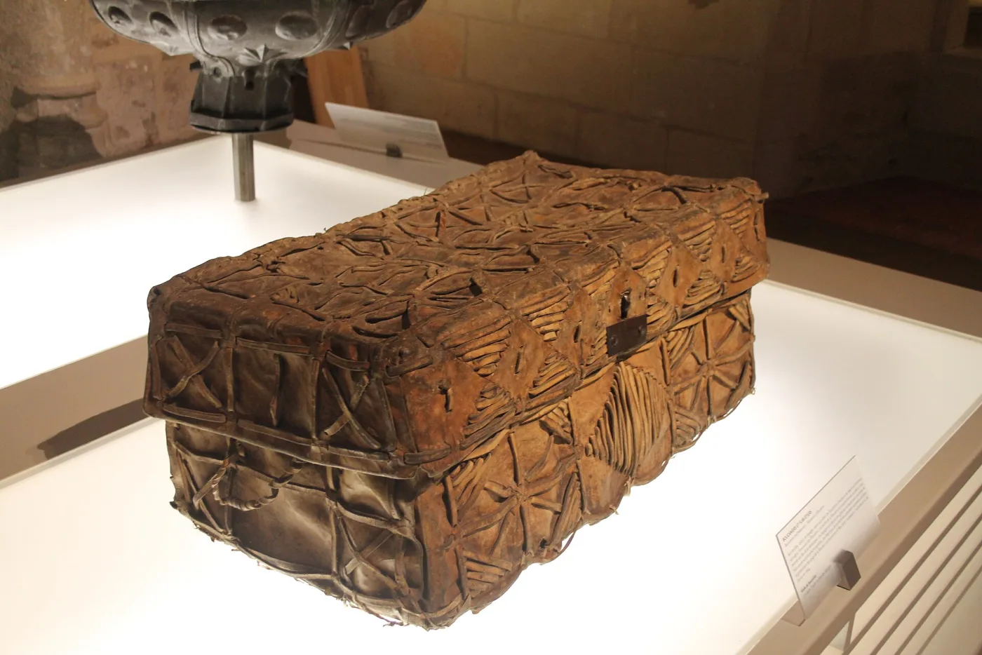 Seventeenth-century domed travelling trunk covered in animal hide with the hair still on it, the covering held down by a lattice of iron studs, the whole worn bare in patches