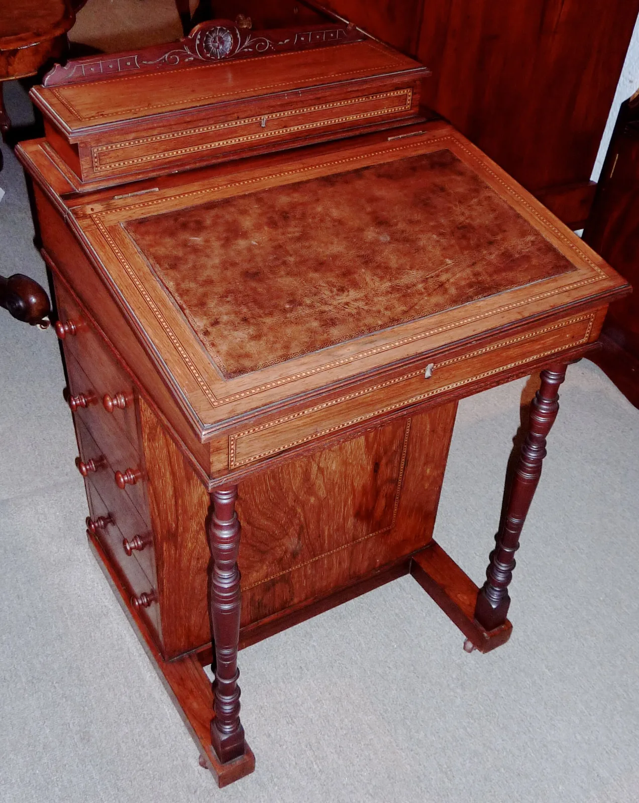 Lighter walnut writing desk of the same form, its every panel outlined in fine pale stringing, with an incised carved gallery and slender ring-turned legs