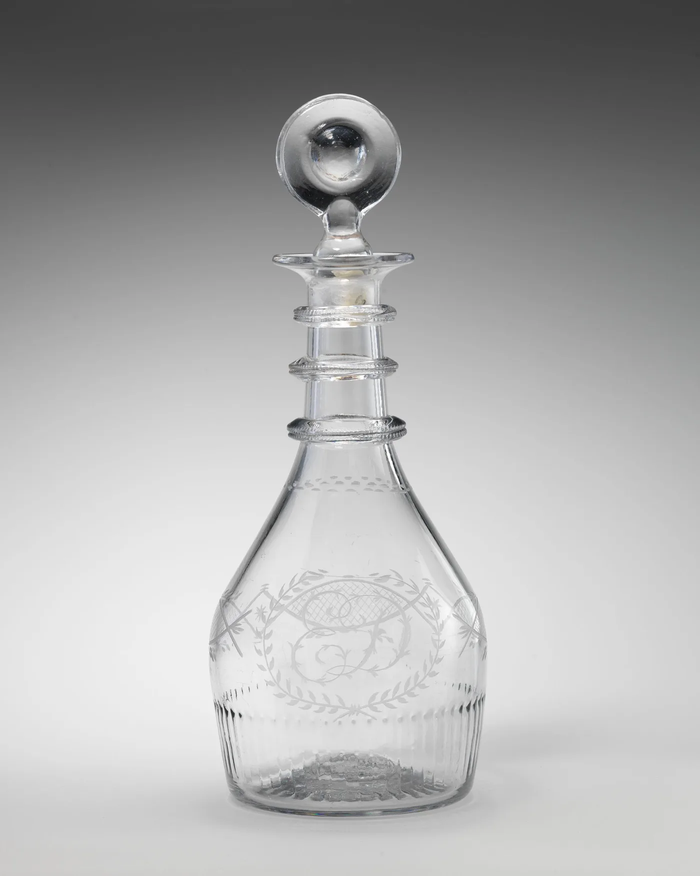 Late eighteenth-century Irish decanter with three notched neck rings, an engraved monogram inside a laurel wreath and a bullseye disc stopper