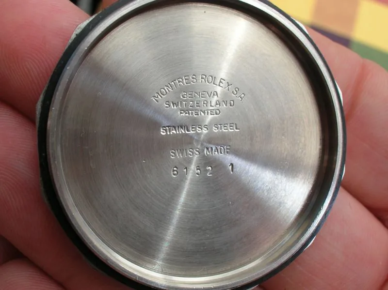 Inside of a stainless steel watch case back stamped Montres Rolex S.A. Geneva Switzerland, Stainless Steel, Swiss Made, and the number 6152